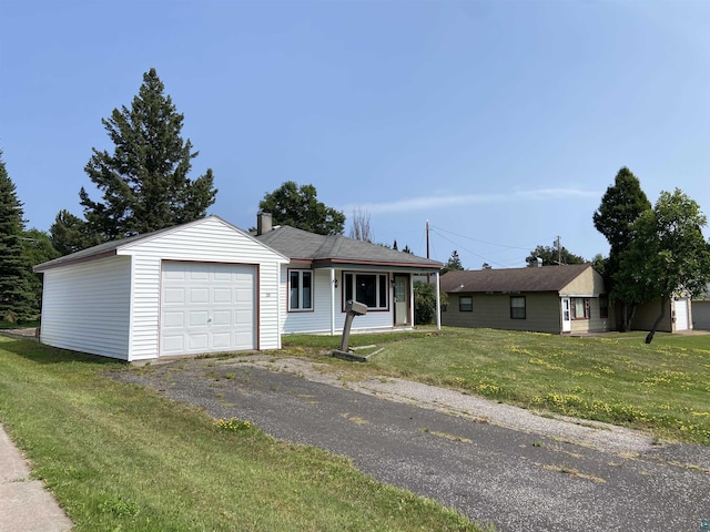 ranch-style house featuring aphalt driveway and a front yard