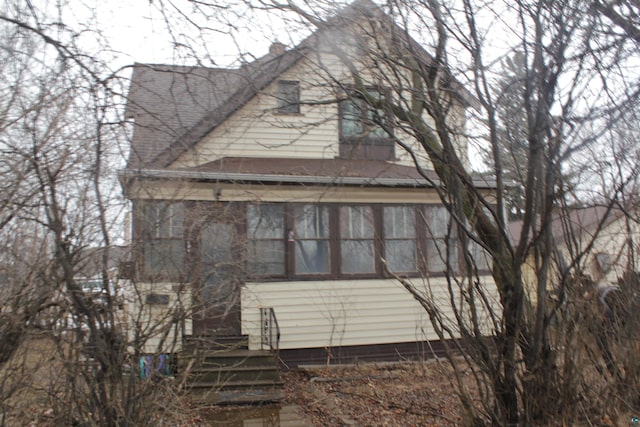 view of side of property with entry steps