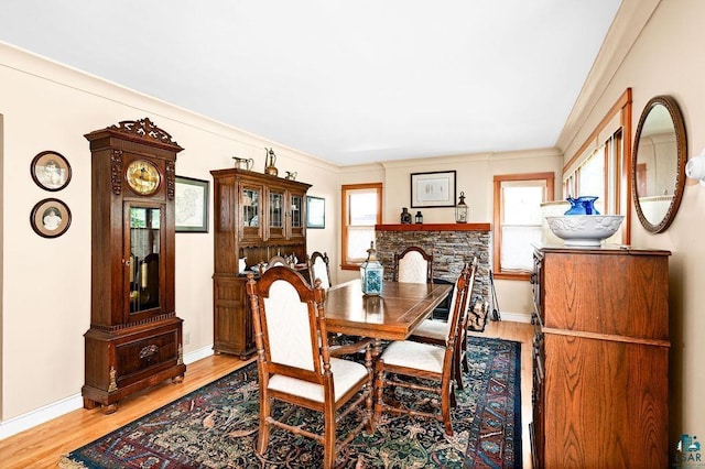 dining space with wood finished floors and baseboards