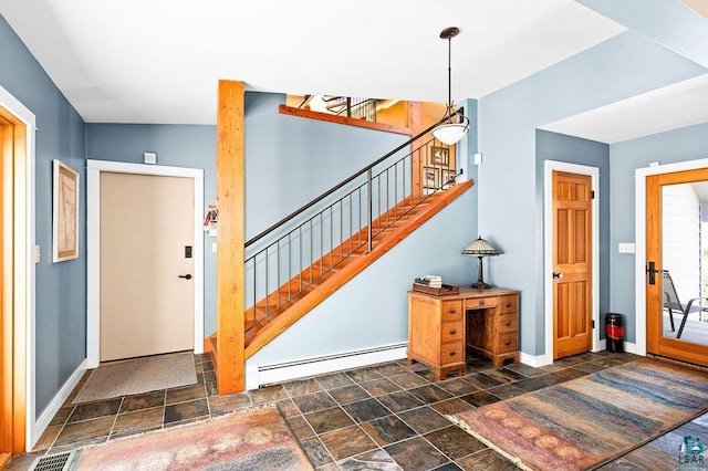 entrance foyer featuring a baseboard radiator, visible vents, baseboards, and stairs