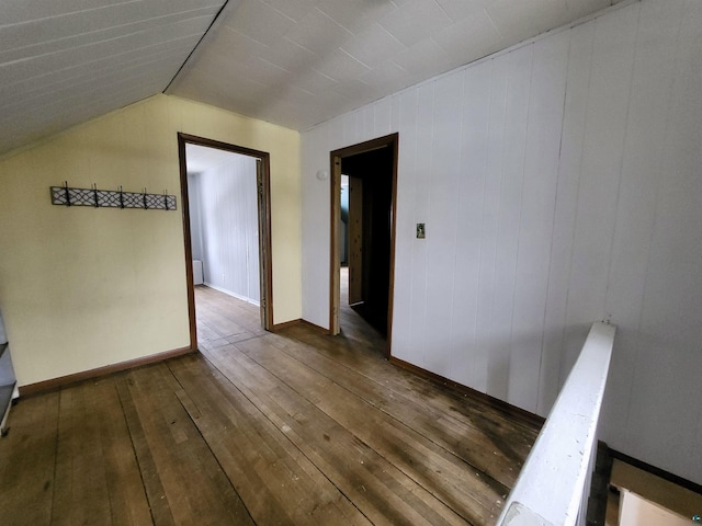 bonus room featuring lofted ceiling, dark wood-style floors, and baseboards