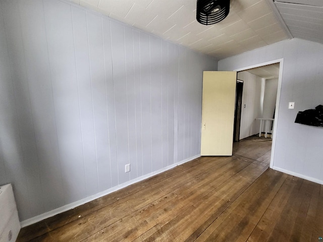 empty room with hardwood / wood-style flooring and baseboards