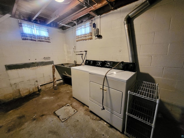 washroom with laundry area, washer and clothes dryer, and a sink