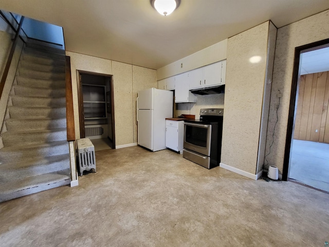 kitchen with baseboards, freestanding refrigerator, under cabinet range hood, stainless steel range with electric stovetop, and white cabinetry