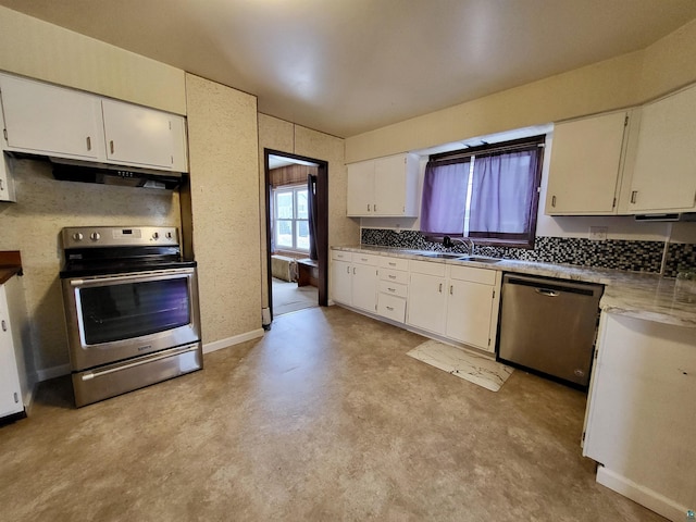 kitchen featuring under cabinet range hood, appliances with stainless steel finishes, white cabinets, and a sink