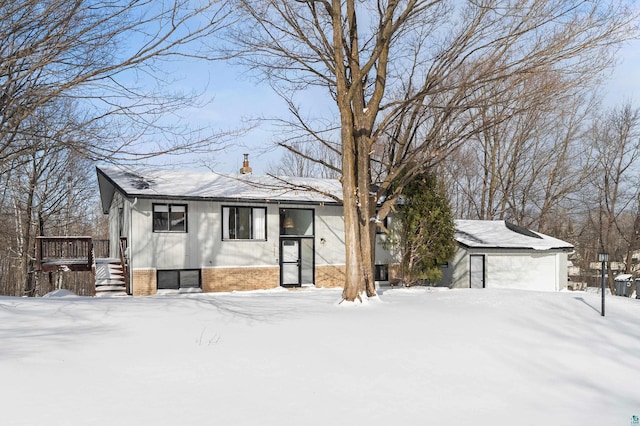 view of front of home featuring brick siding and a chimney