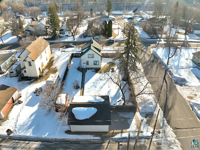 snowy aerial view featuring a residential view