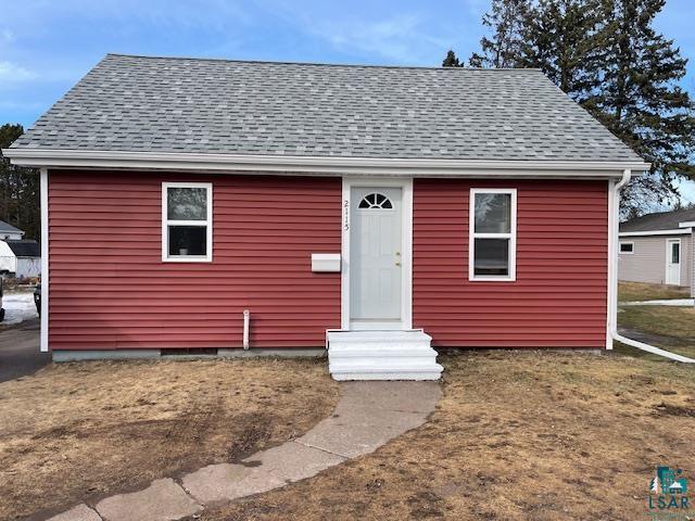 bungalow-style house featuring entry steps and roof with shingles