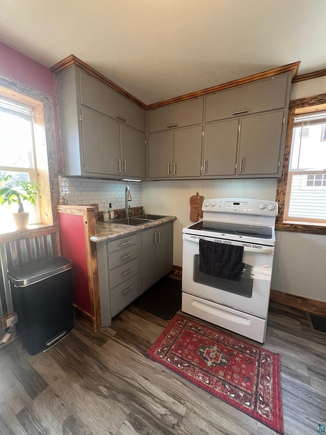 kitchen featuring white electric range, visible vents, plenty of natural light, and gray cabinetry