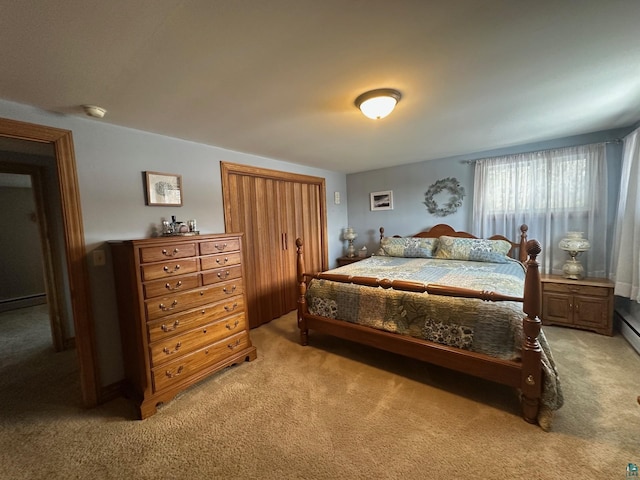 bedroom with a baseboard radiator and light colored carpet