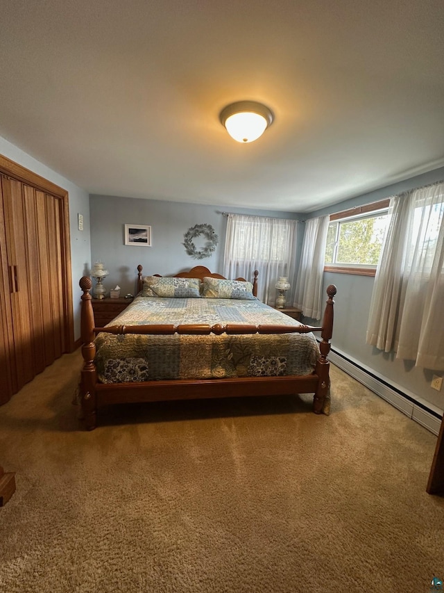 bedroom featuring baseboard heating and carpet floors