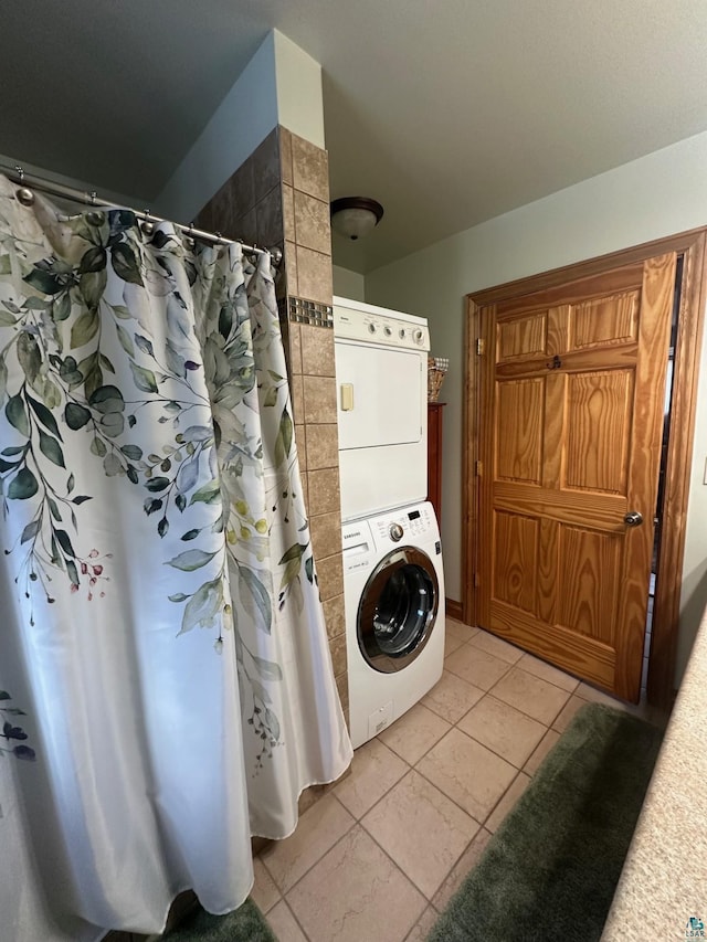 clothes washing area with laundry area, stacked washer / dryer, and light tile patterned floors