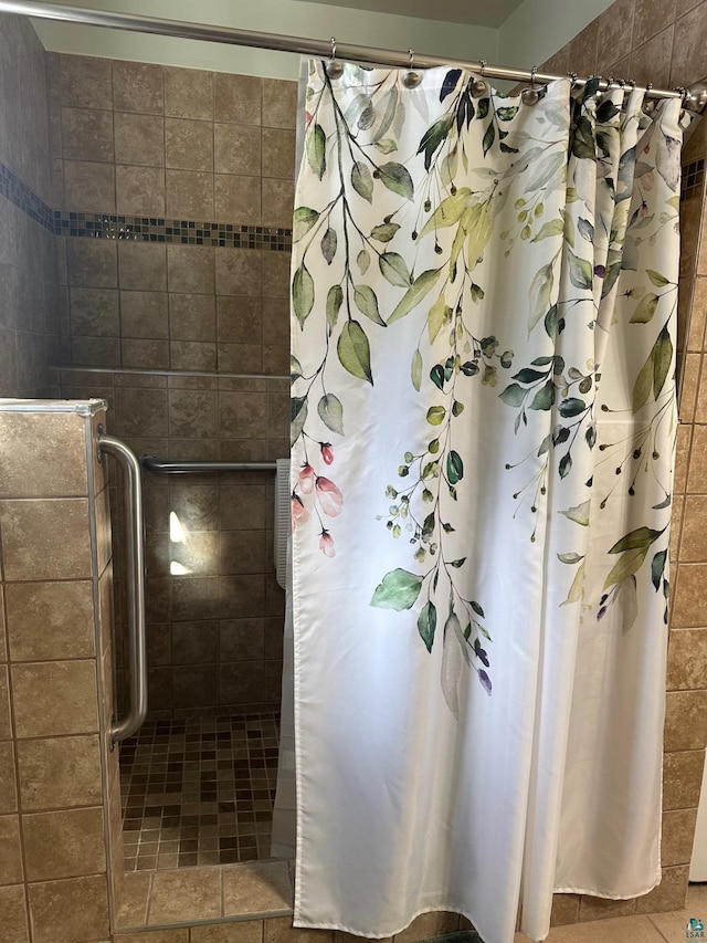 bathroom featuring tile patterned floors and a stall shower