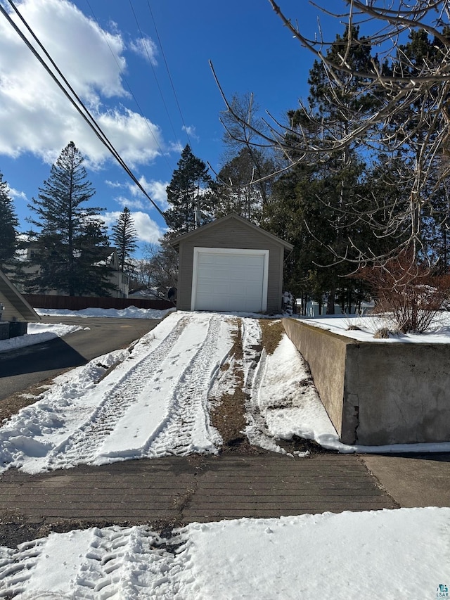 exterior space featuring a detached garage and an outdoor structure