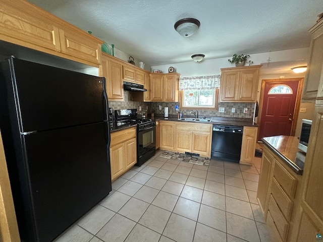 kitchen featuring under cabinet range hood, black appliances, dark countertops, and light brown cabinetry