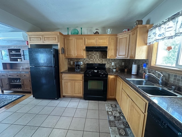 kitchen featuring light tile patterned flooring, a sink, decorative backsplash, black appliances, and under cabinet range hood