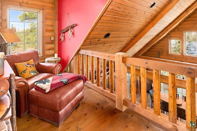 sitting room with lofted ceiling with beams, wood ceiling, wood-type flooring, and rustic walls