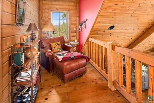 living area with wooden ceiling, log walls, and hardwood / wood-style flooring