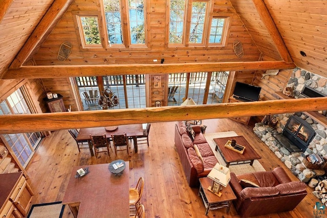 living room featuring plenty of natural light, high vaulted ceiling, and hardwood / wood-style floors