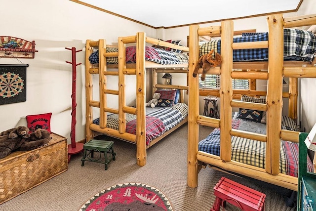 bedroom with ornamental molding and carpet flooring