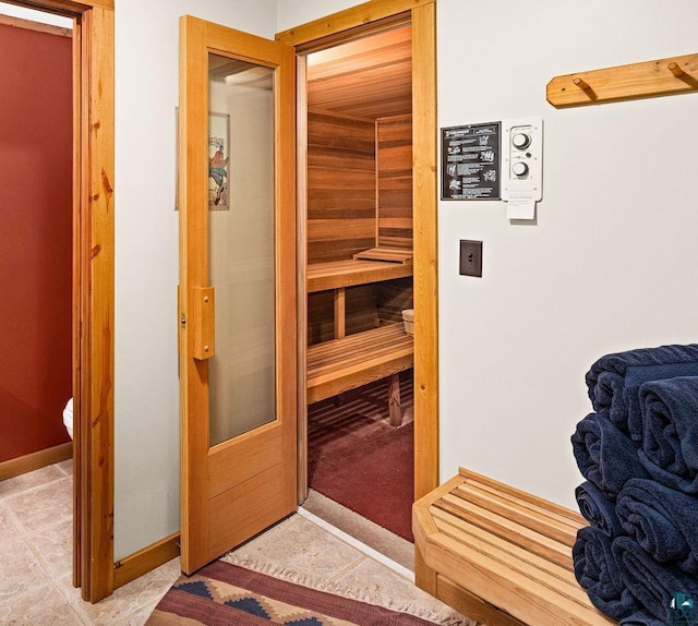 view of sauna featuring tile patterned flooring and baseboards