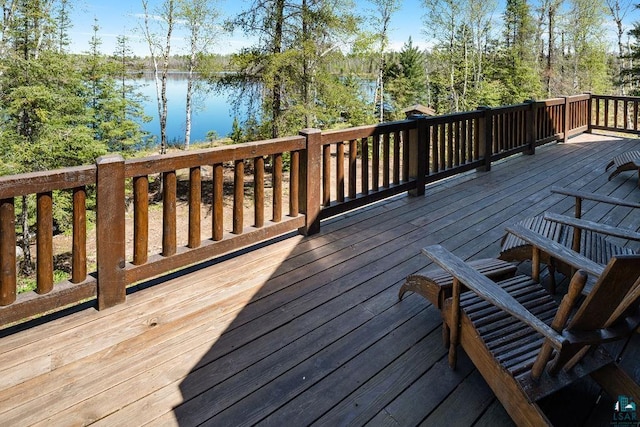 wooden terrace featuring a water view