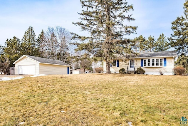 view of front of house featuring a garage, an outdoor structure, and a front lawn