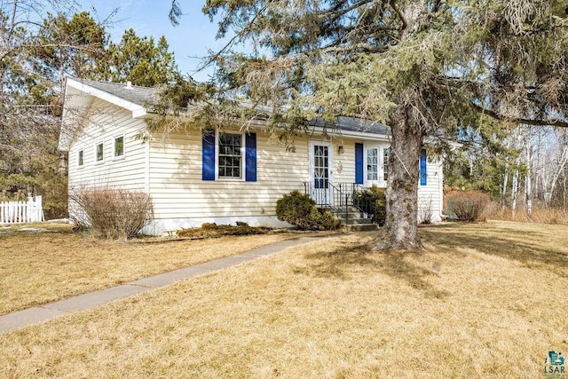 ranch-style house with a front lawn and fence