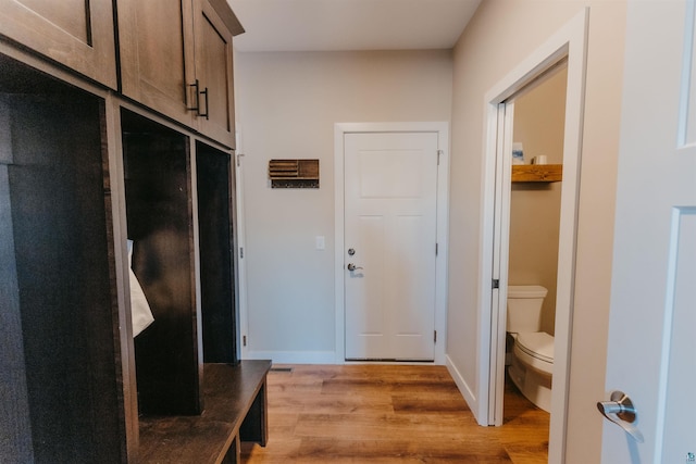 mudroom featuring light wood-style flooring and baseboards