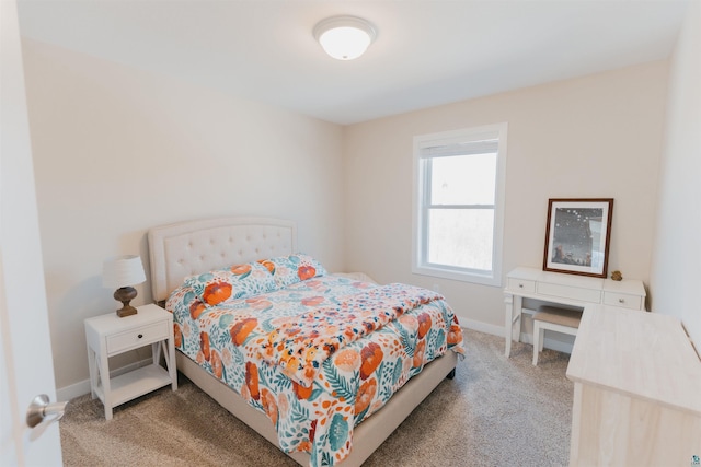 carpeted bedroom featuring baseboards