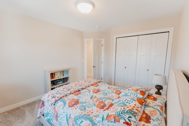 bedroom with carpet, baseboards, and a closet