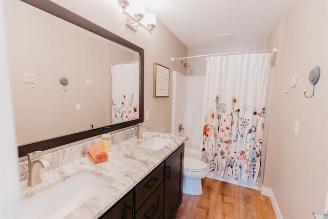 full bathroom with a sink, shower / bathtub combination with curtain, toilet, and wood finished floors