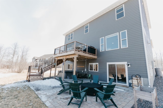 back of property with a deck, a patio, and stairway