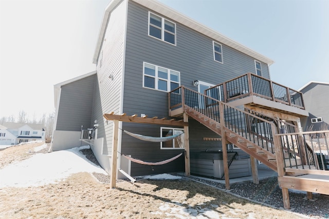 back of property with stairway and a deck