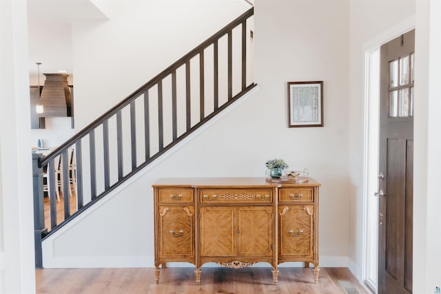 stairs featuring baseboards and wood finished floors