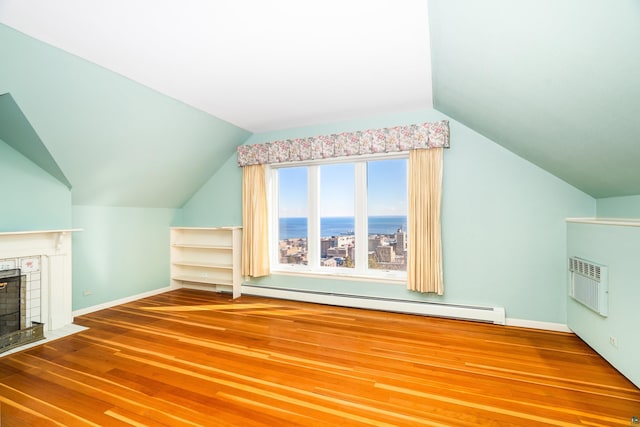 bonus room with baseboard heating, lofted ceiling, a fireplace with flush hearth, and wood finished floors