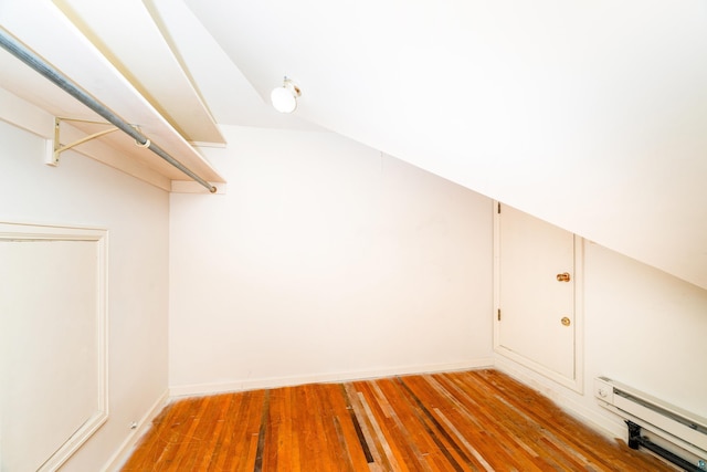 spacious closet featuring light wood-style floors and baseboard heating