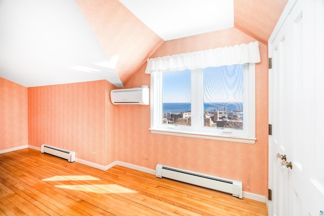 bonus room featuring wallpapered walls, lofted ceiling, a wall mounted air conditioner, and a baseboard radiator