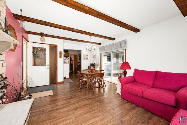 living room with an inviting chandelier, beamed ceiling, wood finished floors, and baseboards