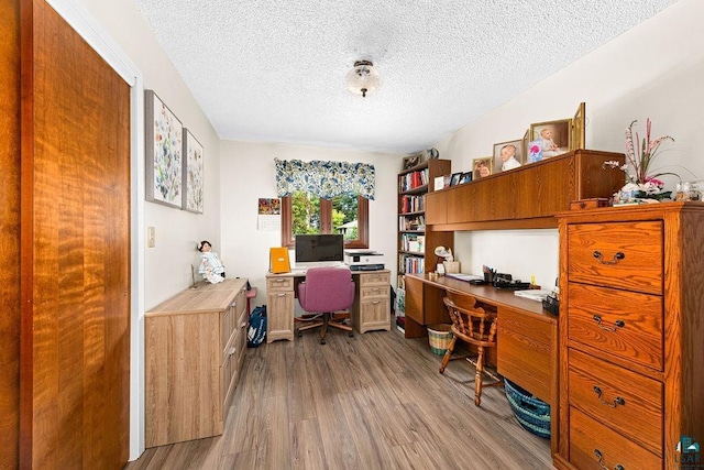 office area with a textured ceiling and wood finished floors