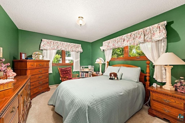 bedroom featuring a textured ceiling and carpet floors