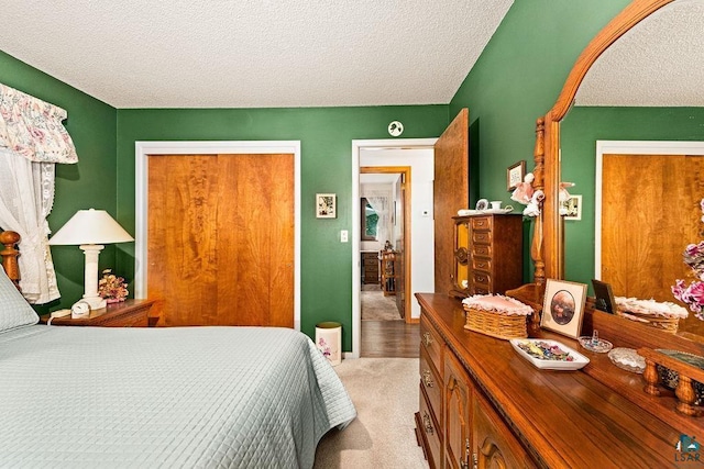 bedroom with light carpet and a textured ceiling