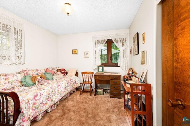 carpeted bedroom featuring a textured ceiling