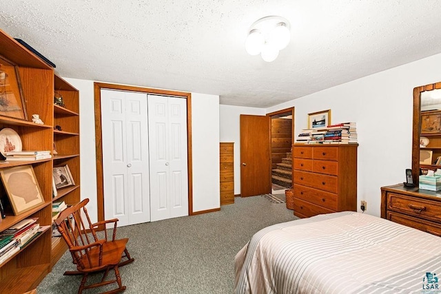 carpeted bedroom featuring a closet and a textured ceiling