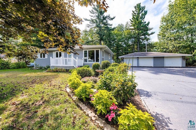 ranch-style home with an outbuilding, a garage, and a front yard