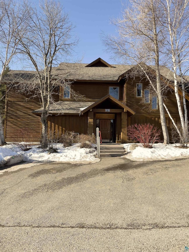 view of front of property featuring board and batten siding and roof with shingles