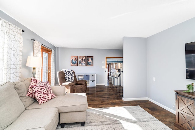 living room with wood finished floors and baseboards