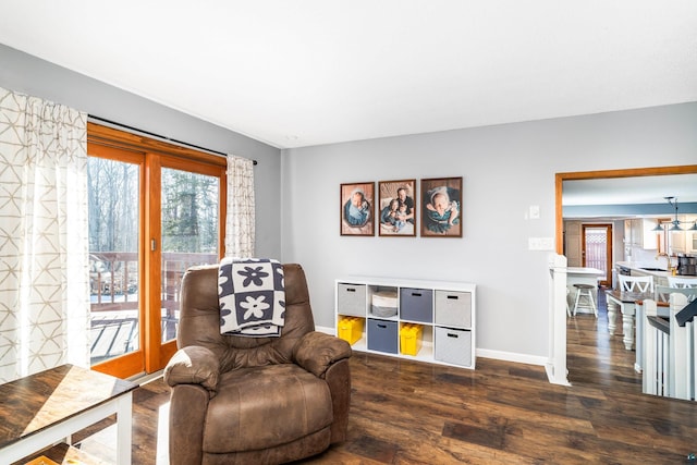 sitting room featuring baseboards and wood finished floors