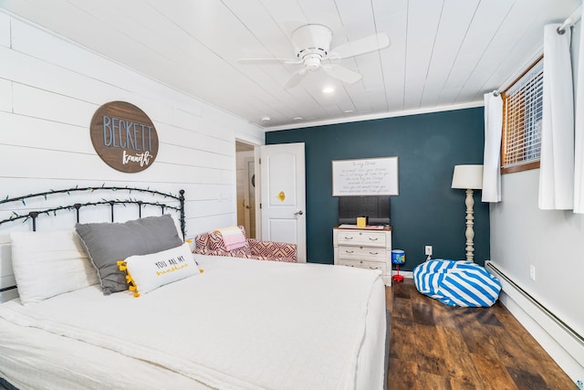 bedroom featuring ceiling fan, a baseboard heating unit, wood finished floors, and crown molding