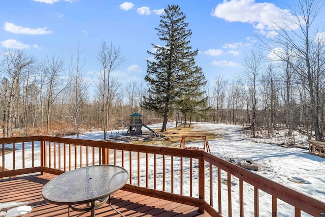 snow covered deck with a playground